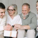Happy family exchanging gifts together, capturing a joyful moment indoors.