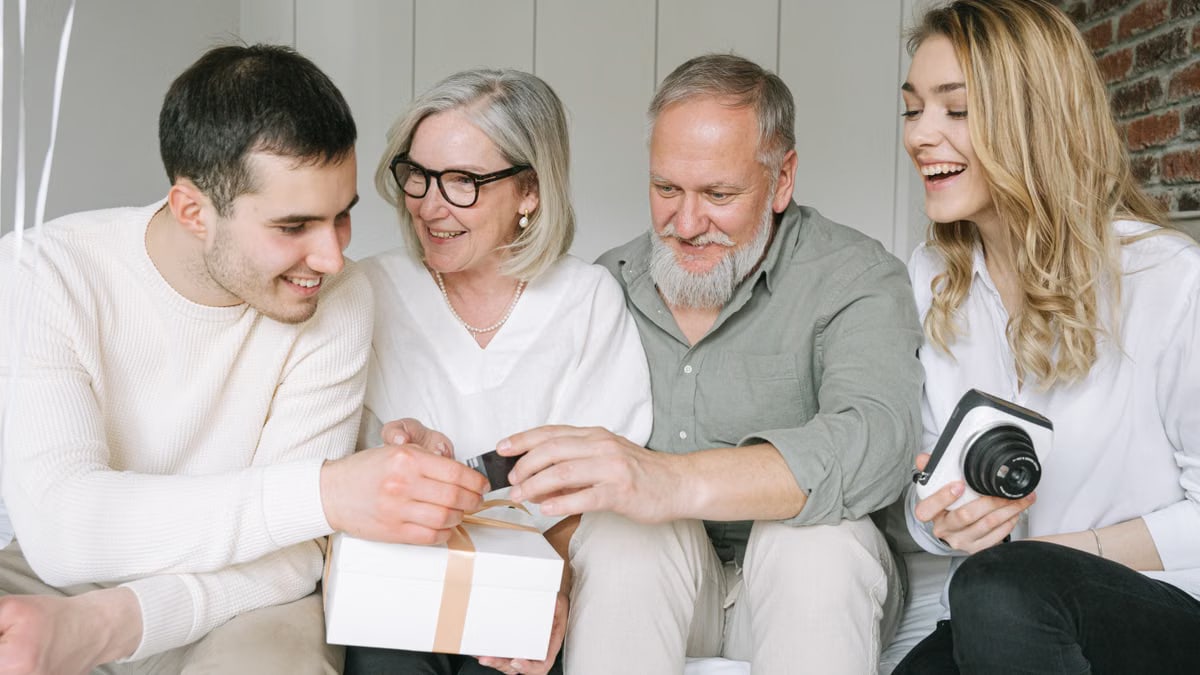Happy family exchanging gifts together, capturing a joyful moment indoors.
